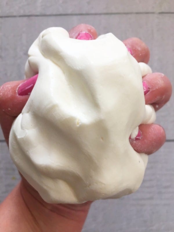 hand holding white dough