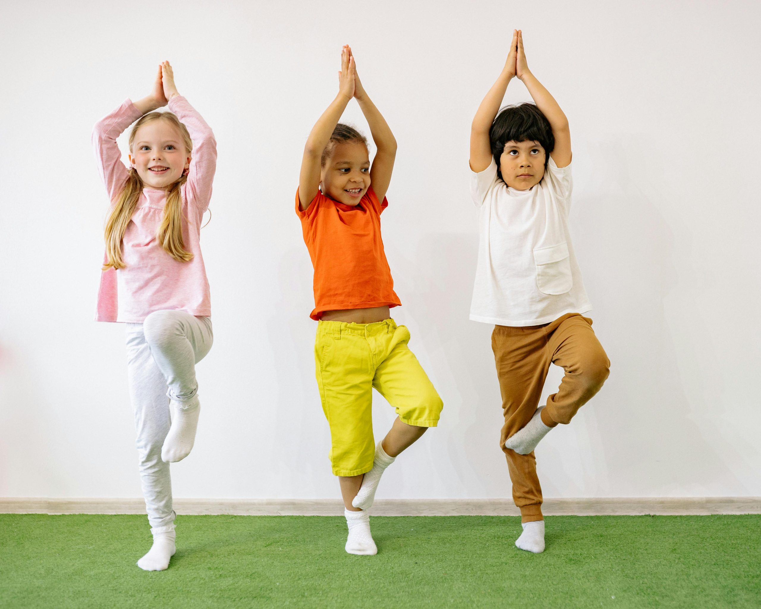 three children doing yoga